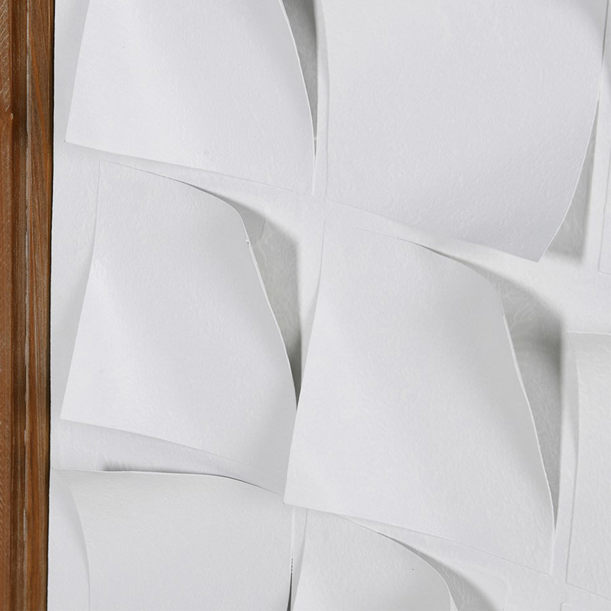 Close-up of a wall art with metal curled details with a wooden frame on a white background