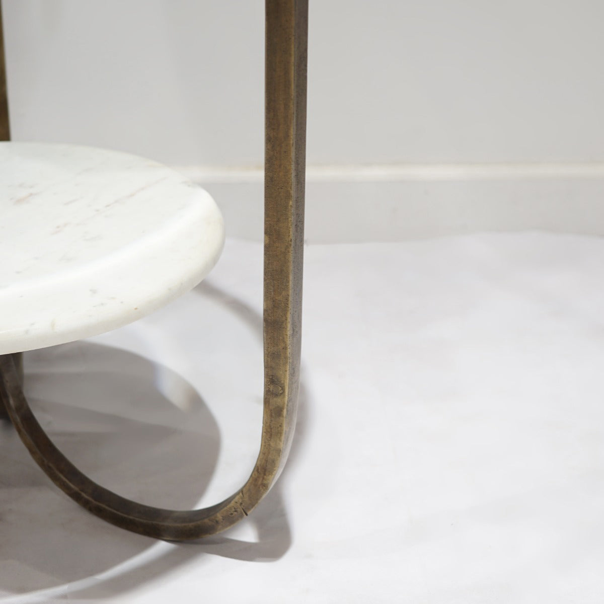 Close-up of a marble table with a metal leg on a white background