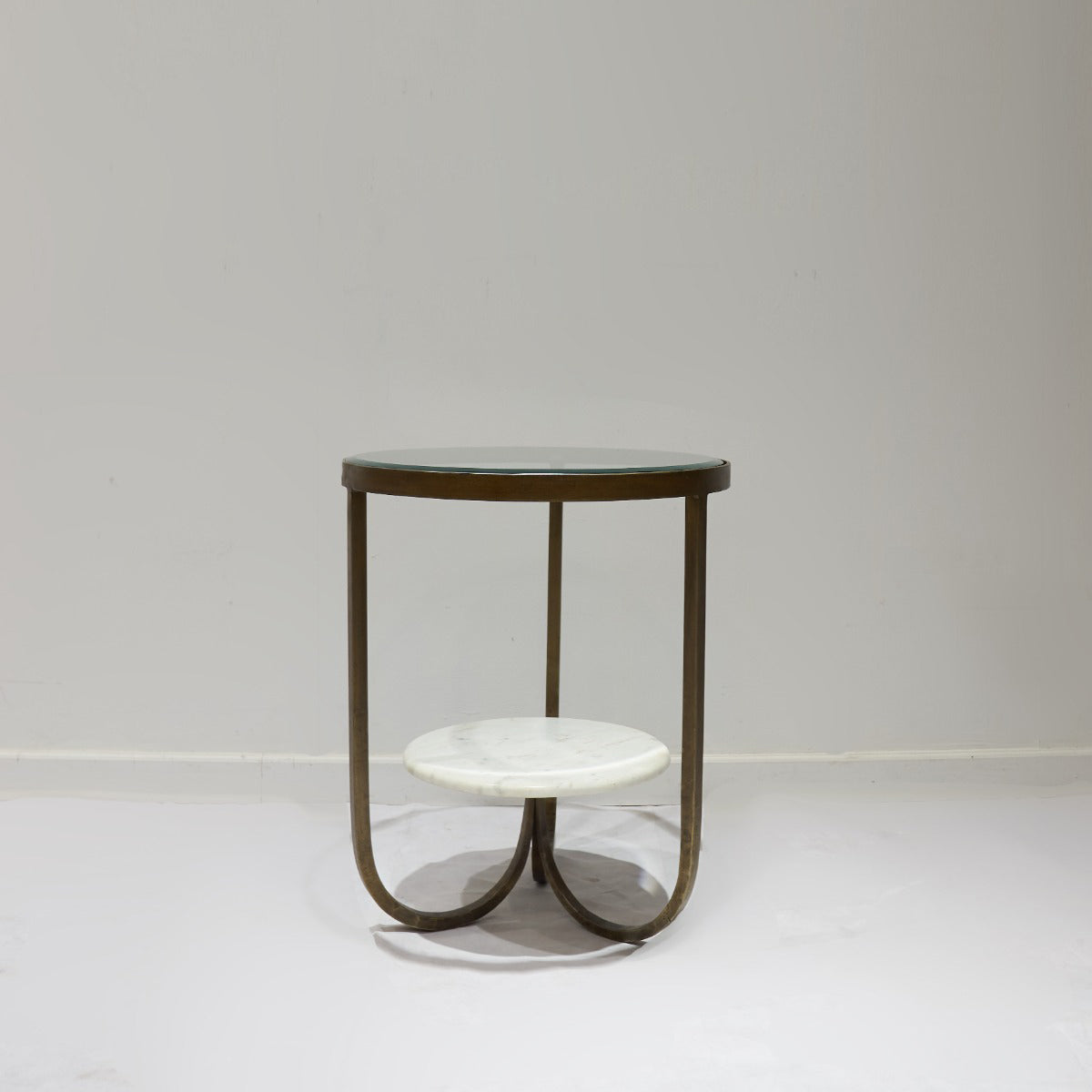 Small round table with a marble top and metal frame on a plain background