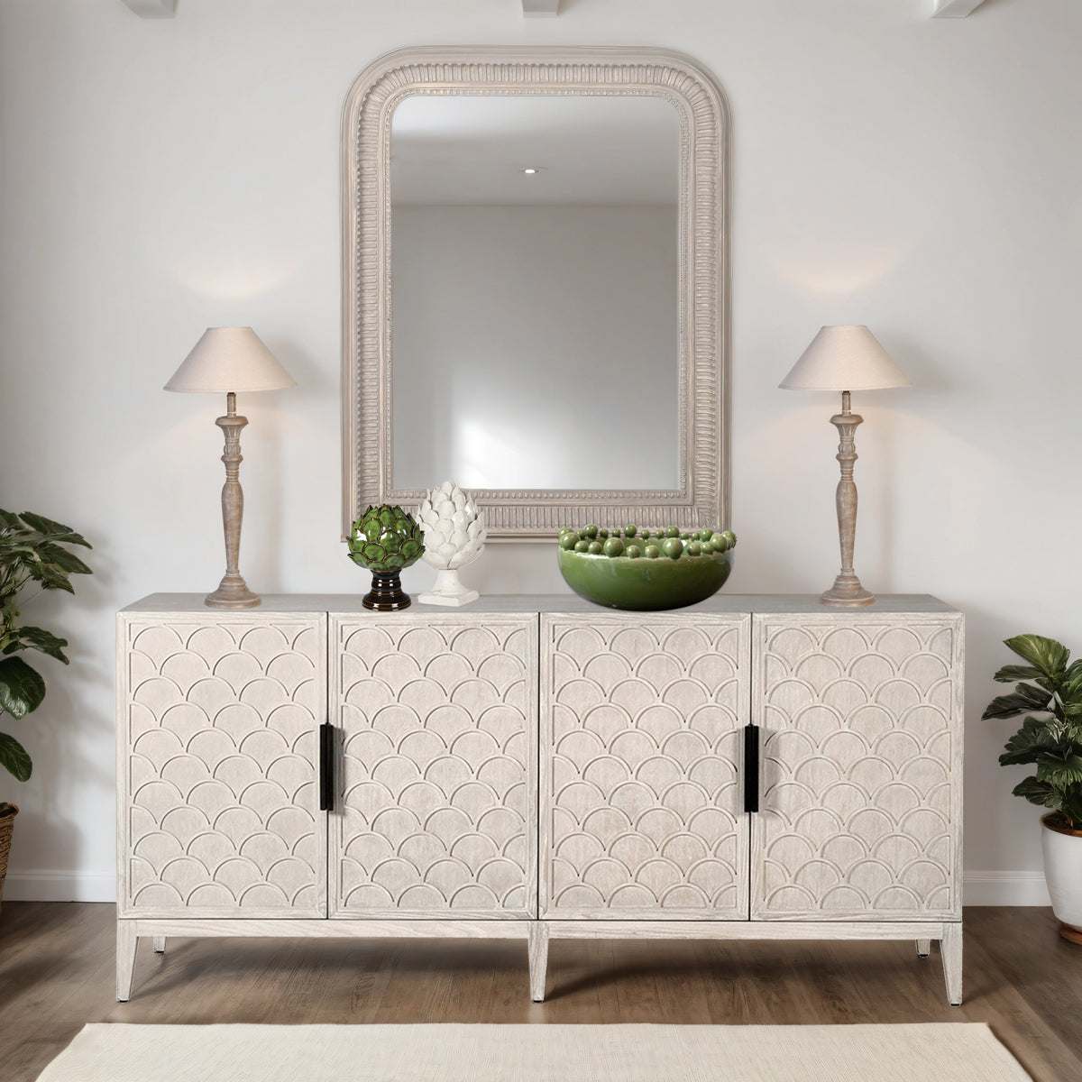 Decorative sideboard with patterned doors, lamps, and plants in a room setting.