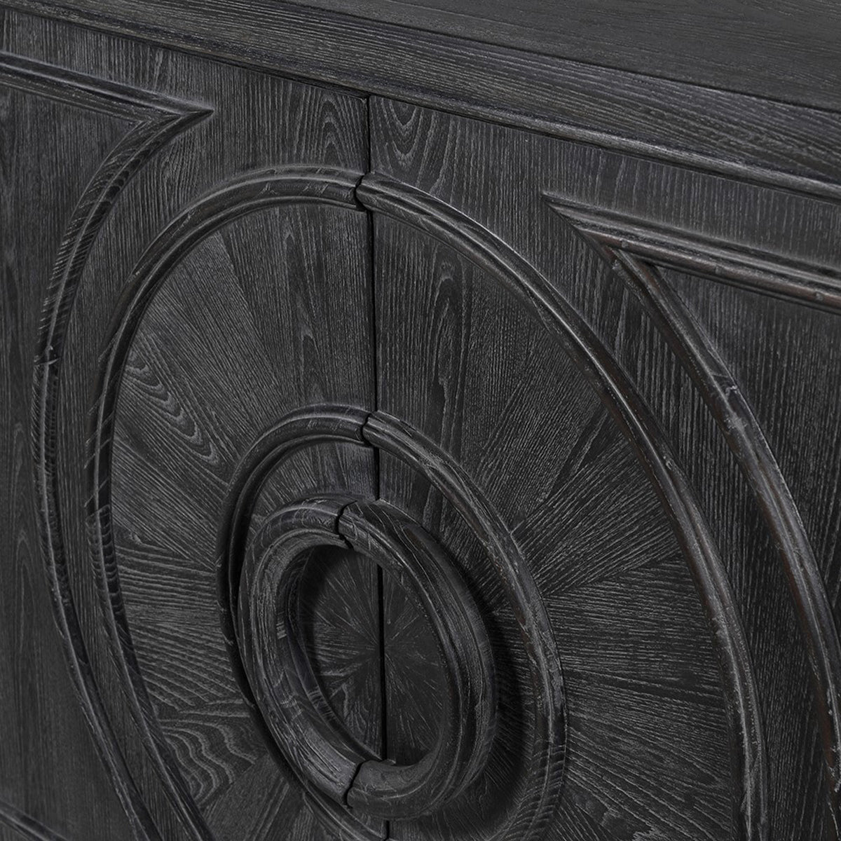 Close-up of a dark wooden sideboard with intricate geometric carvings