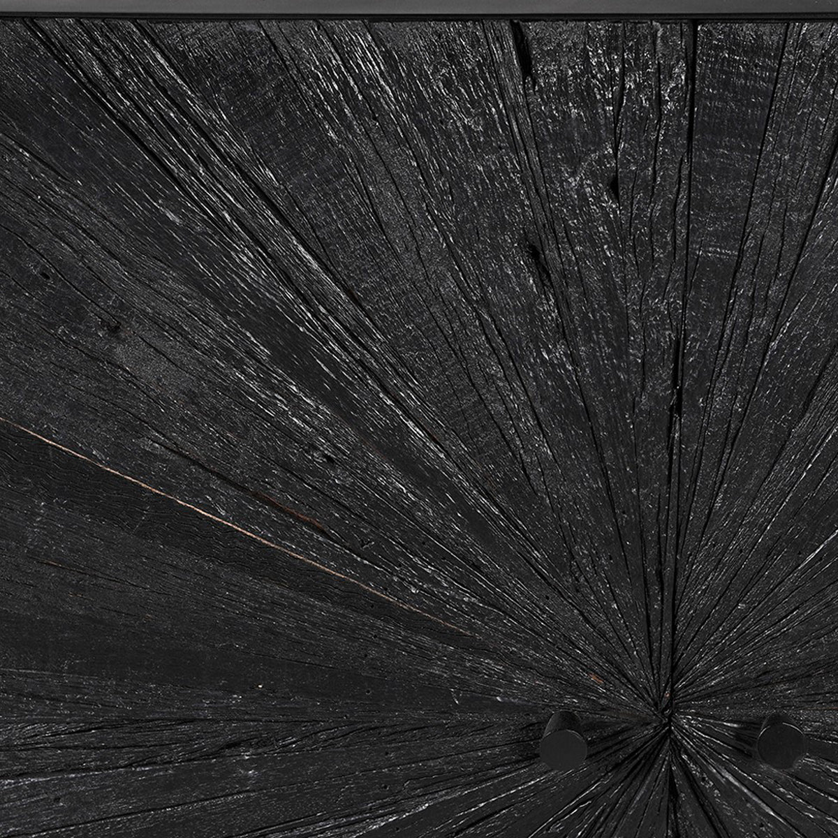 Close-up of a textured black sideboard with radiating lines