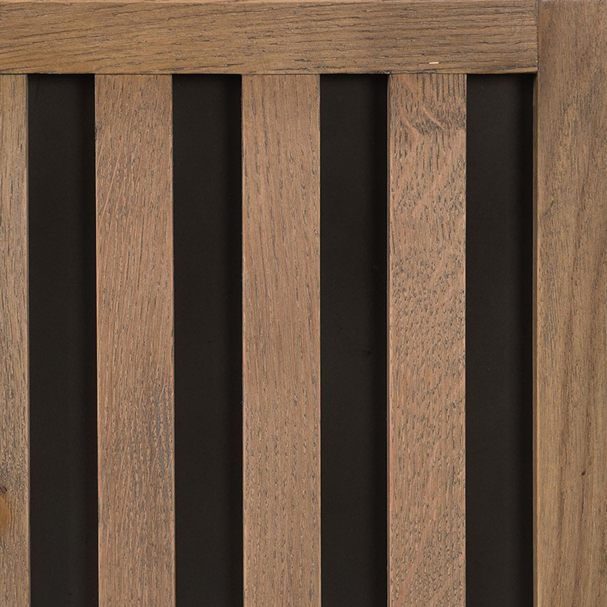 Close-up of wooden slatted sideboard with a dark background