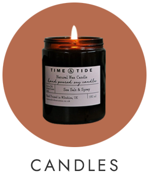 An orange circle with a picture of a lit jar candle in the centre.