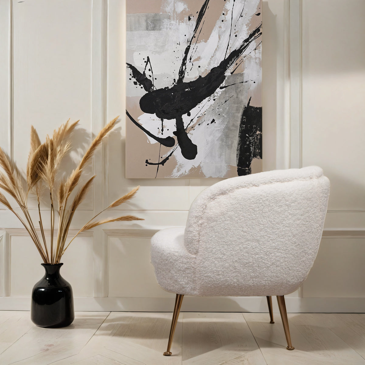 A side view of a white tub chair below a beige & black abstract paint canvas.