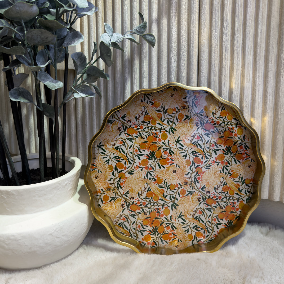 A decorative tray featuring a vibrant floral and cockatoo print showcasing various colorful flowers against a white washed slatted background.